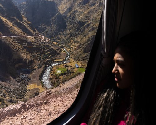 Person working on a laptop beside a bright window in Peru